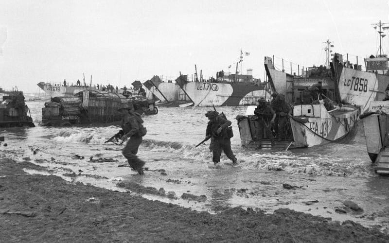 Commandos of 47 (RM) Commando coming ashore from LCAs (Landing Craft Assault) on Jig Green beach, Gold area, 6 June 1944. LCTs can be seen in the background unloading priority vehicles for 231st Brigade, 50th Division.